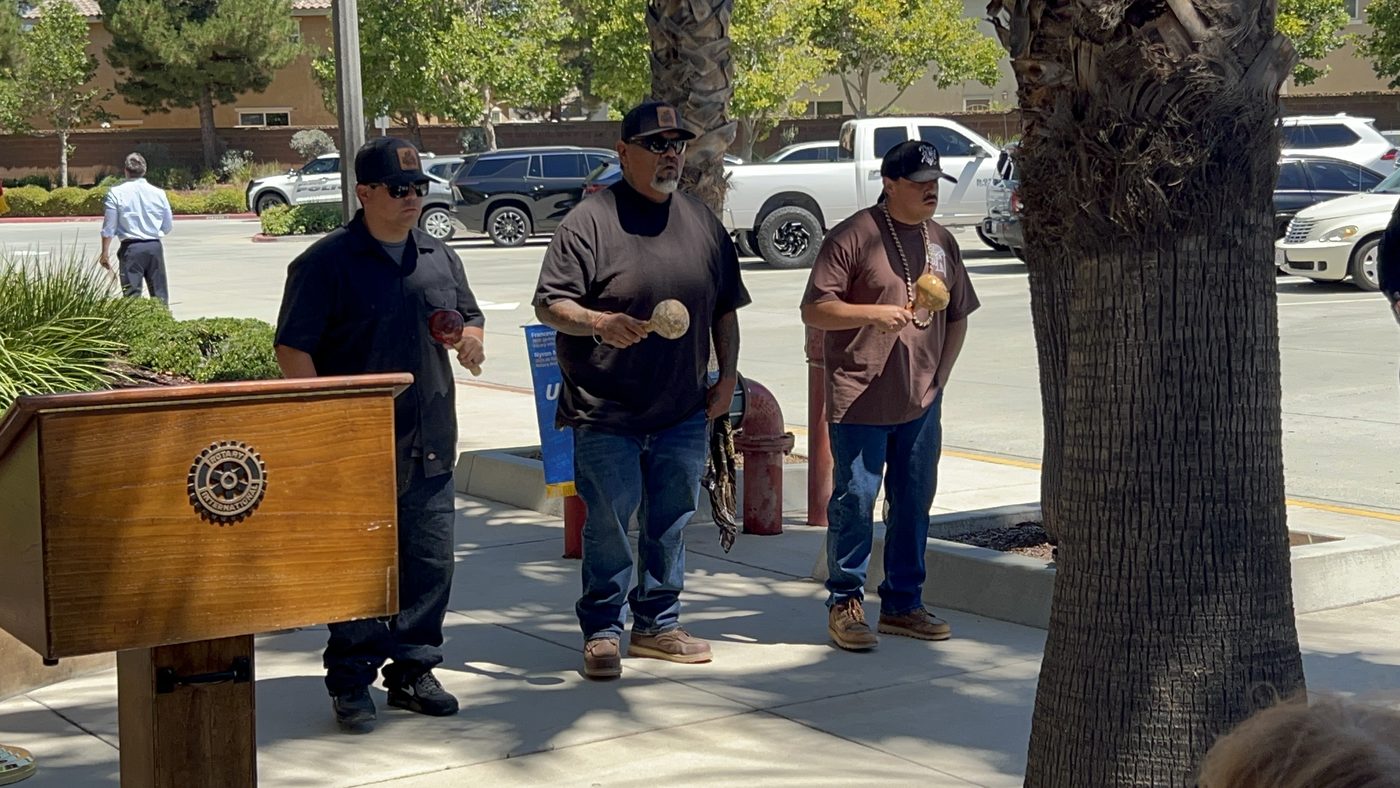 Geronimo Holmes and members of the Morongo Band of Mission Indians Bird Singing Group perform a blessing ceremony with gourd rattles near the Rotary podium