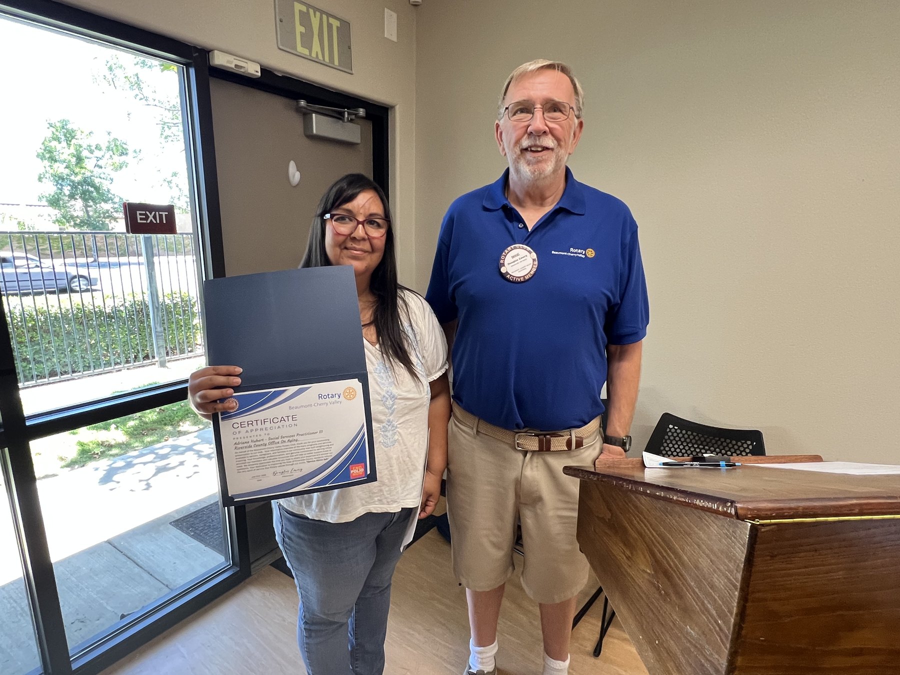Adriana Hubert and President Doug Emery display a certificate following her Riverside County Office on Aging presentation