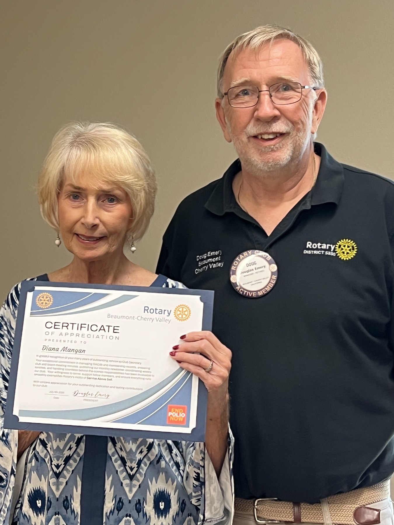 Diana Mangan and President Doug Emery hold Diana's Certificate of Appreciation